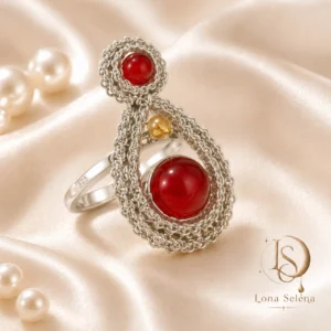 Handmade Lona Selena ring with deep red stone and silver crochet detail